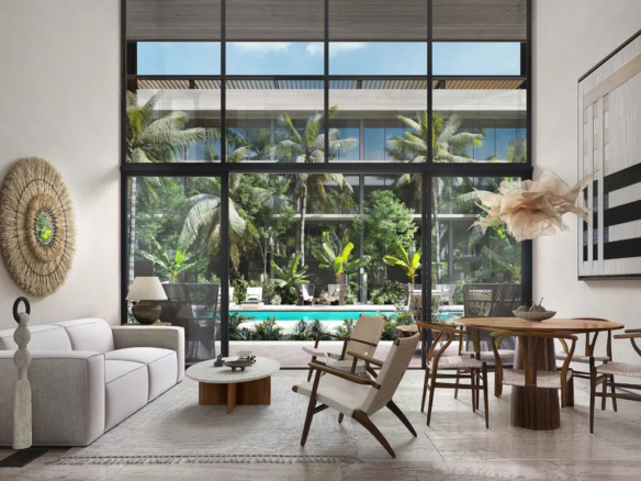Double-height living area of a two-bedroom residence at AURA Playacar, Playa del Carmen.