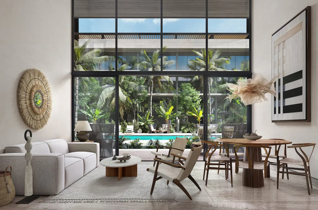 aura-playacar-playa-del-carmen-double-height-living.webp Double-height living area of a two-bedroom residence at AURA Playacar, Playa del Carmen.