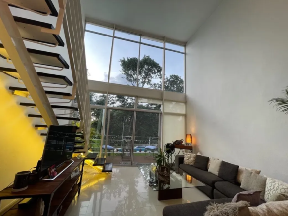 Ground floor living room and terrace overlooking the garden and pool at Condominio Azul Playacar