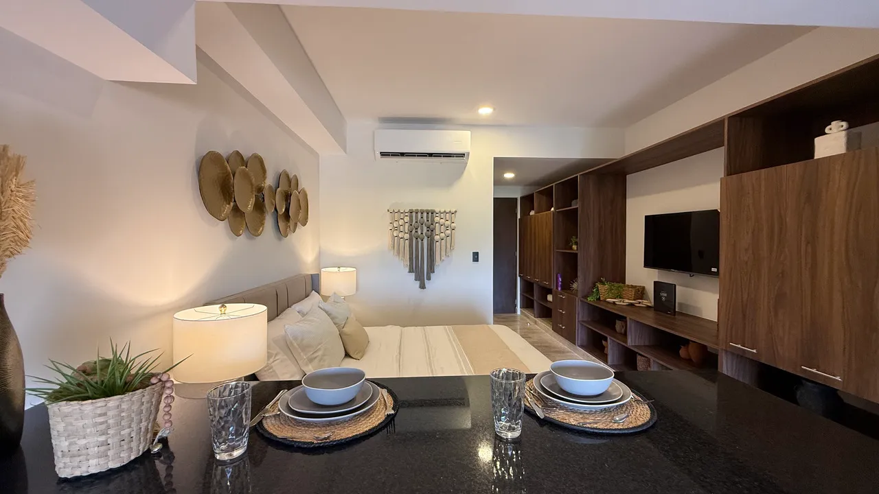 studio-34-playa-del-carmen-condos-studio-interior.webp Interior of a delivered studio at Studio 34 Playa del Carmen showing kitchen and living area