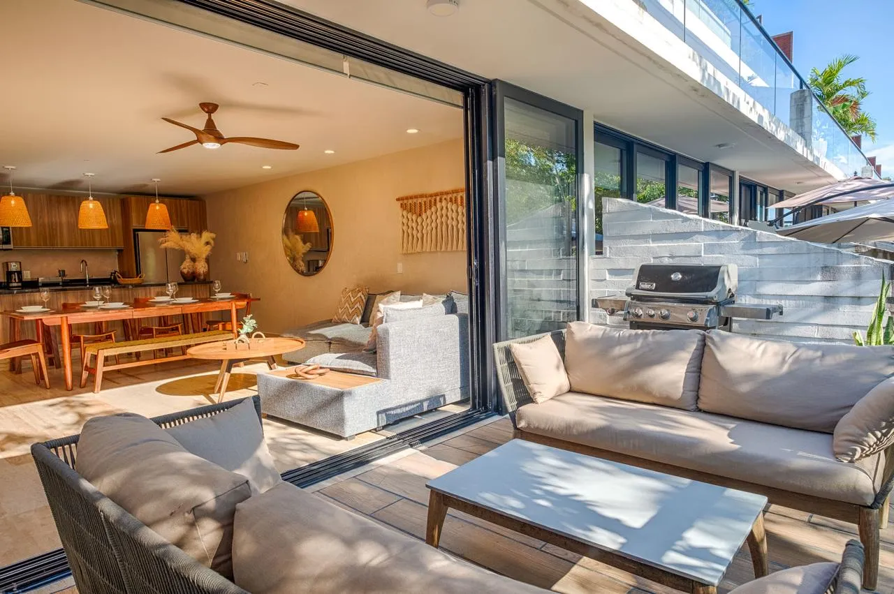 AWA Playacar 2 bedroom condo open-concept living and dining area with designer furniture