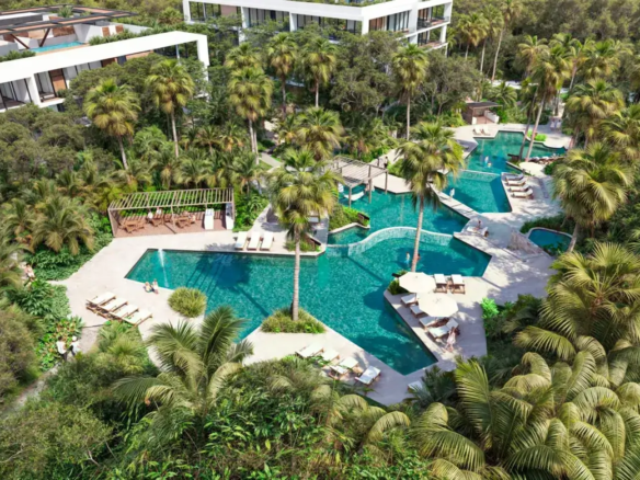 Pools with waterfalls and hammocks over the water at Bakabá, Playacar